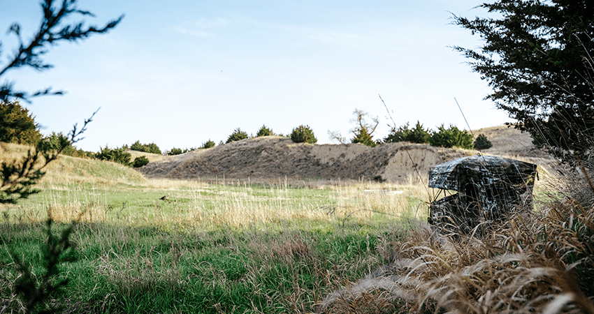 hunter in brown button up shirt and tan hat