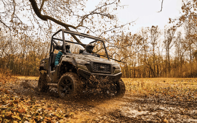 Bass Pro Shops Tracker 800SX LE driving through mud